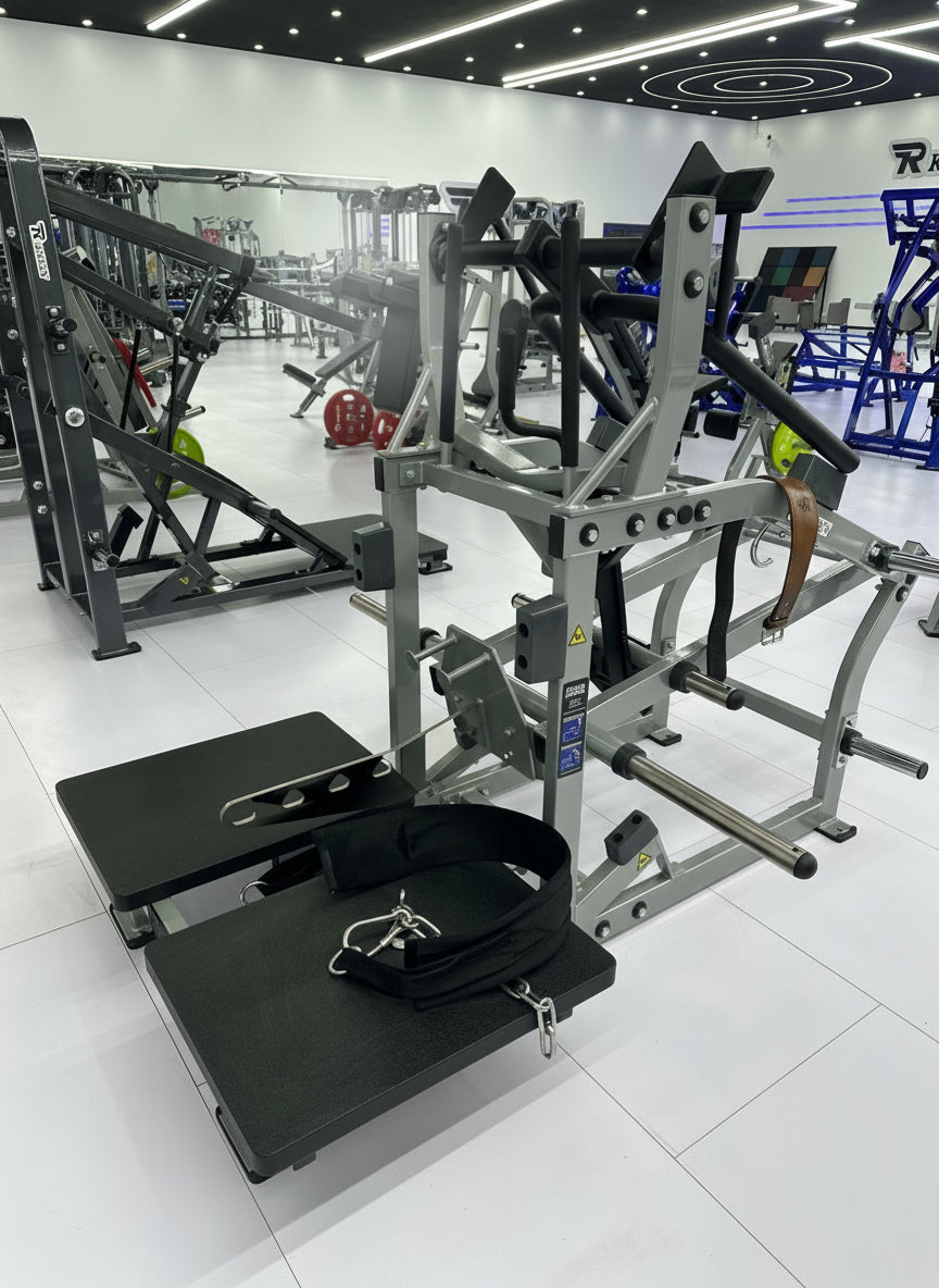 Belt squat and leg press combo machine set up on platforms in a modern gym