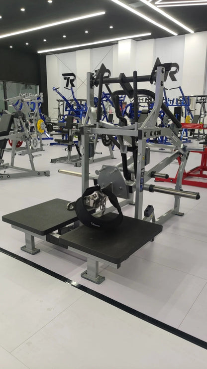 Full view of a belt squat and leg press platform station in a commercial gym interior
