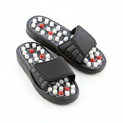 Flexora black acupressure massage slippers with white and red massage nodes on a white background