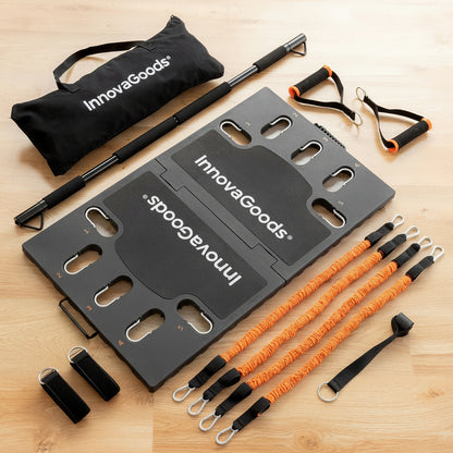Flexora portable training system laid out on a wooden floor – black foldable platform, orange resistance bands and accessories