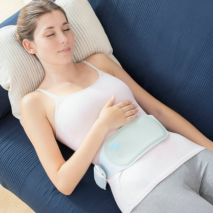 Flexora rechargeable massage and heat belt on the abdomen while lying down