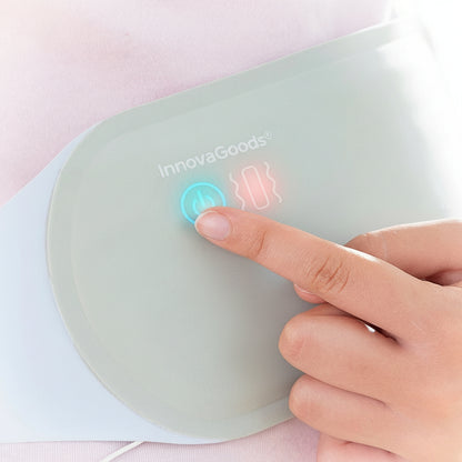 Hand pressing the control button on the Flexora rechargeable massage and heat belt